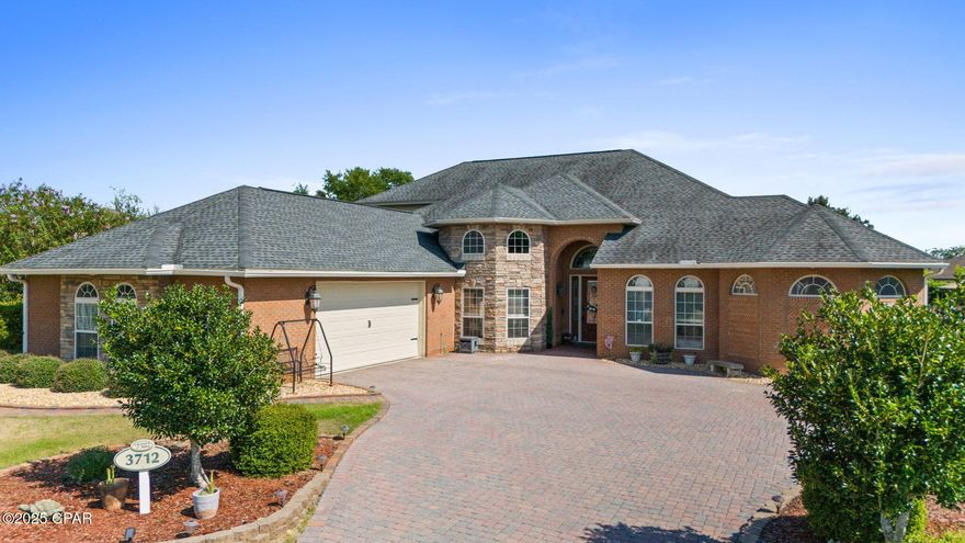 Elegant custom pool home in the Grant's Mill community located in Lynn Haven, this custom residence sits on a private half-acre cul-de-sac lot.  Inside, you will find hardwood floors, 12-ft ceilings, and an open layout designed for entertaining.  The chef's kitchen features granite countertops, premium stainless appliances, breakfast bar, and walk-in pantry.  The primary suite is a true retreat with dual walk-in closets, spa-style walk-through shower and separate bath, with patio access. Spacious secondary bedrooms plus a versatile upstairs bonus room offer room for media, fitness, or guests with private bath.  Step outside to a brick exterior, sparkling saltwater pool with waterfall feature, screened patio and outdoor kitchen-- gazebo sitting area perfect for year around gatherings. This home's central location to Publix, two charter schools, public schools.  Military affiliated families are 25 minutes out from Tyndall Air Force Base and the Navy Base.  Only minutes away from a boat launch and Lynn Haven's Bayou Park and Preserve.  Roof 2019-Gutters-Tankless water heater-Outdoor Kitchen-Over-sized garage