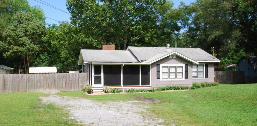 Centrally located 4 bedroom on almost one acre! You don't find this very often,yard is fenced in with a inground pool and workshop(S).The home has been updated over the years, most recent are all new paint, laminate flooring throughout, and backsplash and floor tile in kitchen. Sellers removed the old ceiling tiles and replaced with drywall in kitchen, family/dining and living room. The kitchen has plenty of cabinet and counter space along with a pantry. The master bathroom has a clawfoot bathtub/shower combo and just completes the look of this eclectic bathroom. The large room between living room and kitchen can be used for dining room, family room, or sitting area.The back yard has two large buildings/workshops measuring 17x24 and 20x24 and both have roll up doors, one has power. They both are are on concrete slabs and there is one more covered building on a concrete pad with a seperate fence around it. The pool is inviting on these hot summer days. A one year home warranty will be offered by seller with acceptable offer.  Flood Insurace runs $480.00 a year.