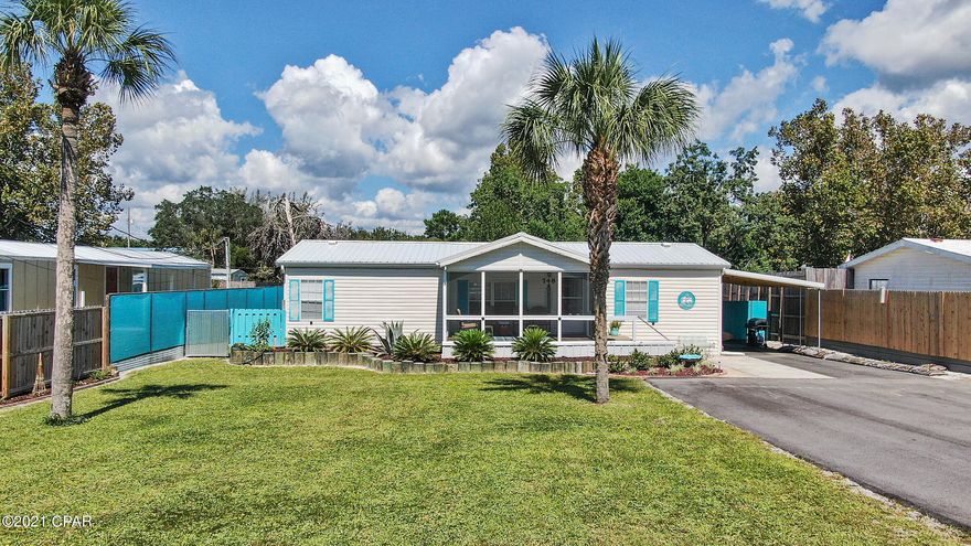 CURRENTLY UNDER CONTRACT, SELLER ACCEPTING BACKUP OFFERS Wonderful beach home, fully furnished with a private salt-water pool! Come see this well-cared for and updated 4 bed, 3 full bath double-wide mobile home on the west end of PCB. This home will not disappoint, with two master suites and an updated kitchen with stainless steel appliances. The main living area has been updated with a solid wood ceiling and vinyl plank flooring. What a beautiful and spacious home! New roof in 2018, A/C approx. 6 years old. The paved oversized driveway is a great feature to hold all your family vehicles, golf cart, boat, and RV! There is also a carport and a yard building! Turquoise fencing gives this property a pop of color so you feel that beach vibe right at home while enjoying your private pool! This home would make a great primary residence or second home.

Notes: Light up faucets, Bluetooth speaker bulb in second master bath. New electrical - 30 AMP service, water heater 8 years old, sprinkler/irrigation for landscaping around front porch, no separate meter, no well on property. Pool is 4.5 feet deep, 2 years old with salt water generator. 6x6 construction around pool with underground reinforcement. Tall fence on east side of property belongs to neighbor. 5/8th inch cut plywood hurricane panels in shed for all windows. Window sensor alarms are present for security but not serviced by an alarm company. There is a small list of furniture/personal item exclusions.