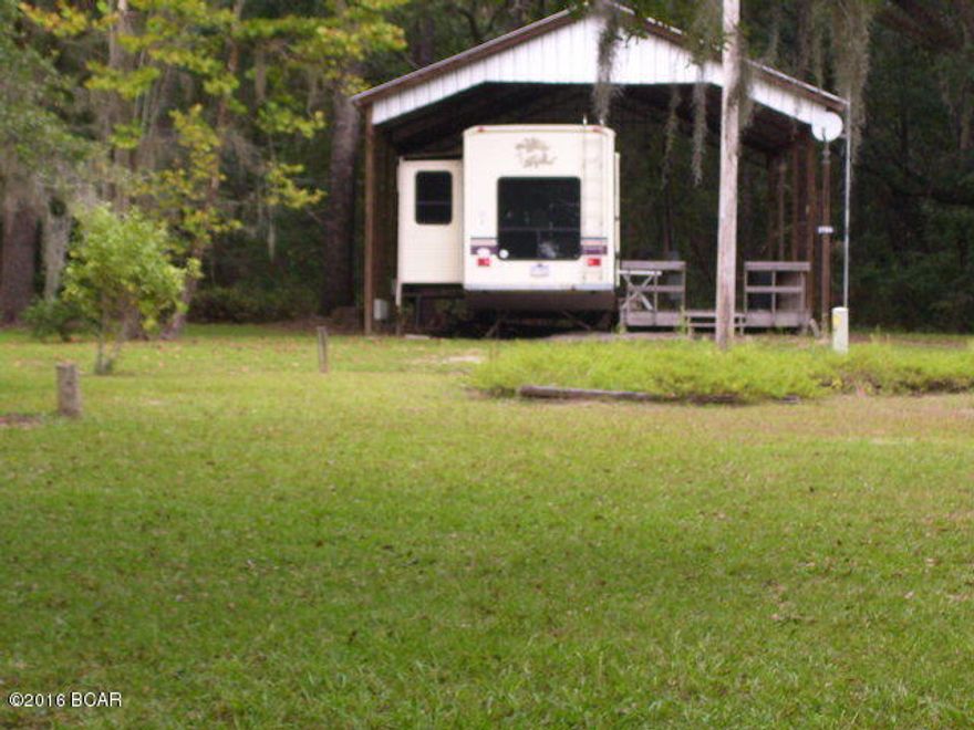 Great vacation/fishing camper with a roof over the 1994 camper with two slide outs. Comes furnished with exception to personal items. Roof over large deck with built in barbeque outside. Across from the head of Lake Ocheesse with private boat ramp access. Owner maintains the ramp and surrounding area for a yearly fee. Well on this property is shared by two other lots. Big storage building and lean-to for boats. Boats not included in sale. Very serene and the lake awaits for some good fishing and fun. The camper is very comfortable and has lots of storage. Copy of deed,title to camper, and agreement/restrictions on file in office. FISH ON!