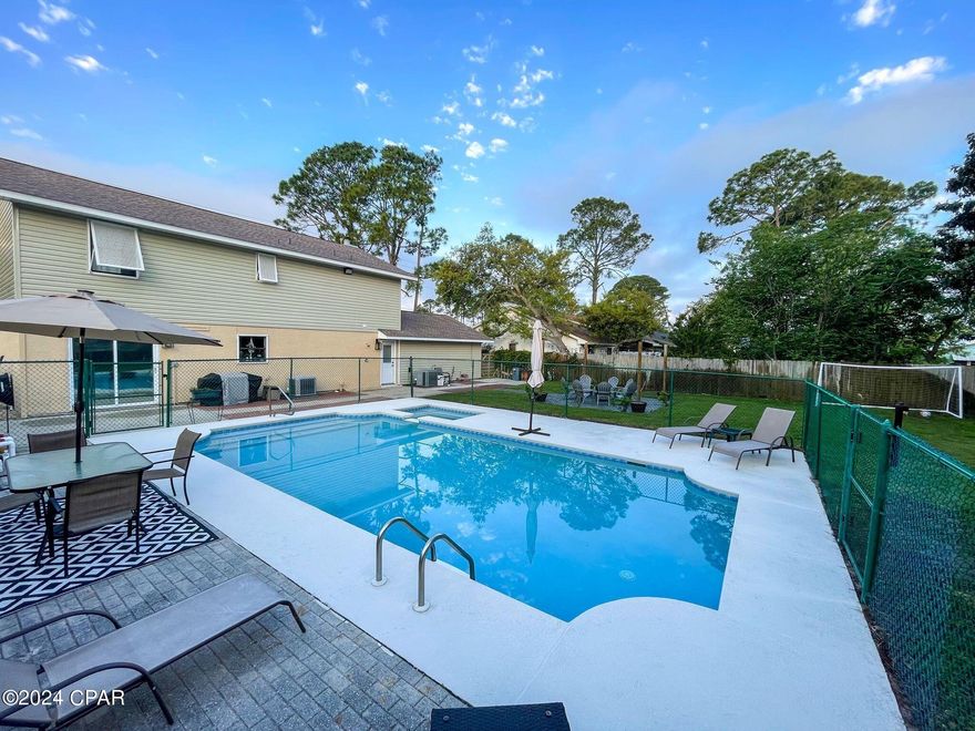 You don't want to miss this stunning four bedroom home with an amazing pool and upgrades galore! As you step inside, you'll immediately notice the open foyer with a multifunctional space to the left and living room to your right.

 New windows have been installed in the two living spaces for reduced energy costs! The heart of the home is undoubtedly the kitchen, where a new Tongue and Groove ceiling adds charm and character. The kitchen also features USB receptacles, stainless steel appliances, a stainless-steel farmhouse sink, and an ample amount of storage.

 The multifunctional space features a wood burning fireplace, making it a perfect space for relaxing! Upstairs you will discover the private retreat of bedrooms. The master bedroom offers two walk-in closets, providing a ton of storage. One of the closets features a network closet catering to modern technological needs. The other three bedrooms are located across the hall. All bathrooms have been remodeled except for the master (was previously remodeled). 

When you step into the backyard, you'll discover your own private oasis. The backyard is highlighted by a newly resurfaced pool, perfect for cooling off on hot summer days. A newly paved patio also awaits, enhanced with ambient stringed lighting, creating the perfect atmosphere for outdoor gatherings. Sellers added landscape lighting and Wi-Fi enabled dimmer switches for exterior lighting. 

This home is not just beautiful, but also practical, with security cameras providing peace of mind and the garage features a 50A electric car charging receptacle. Other upgrades include fresh paint on the front stucco along with brand new stone on the chimney and house skirt, new storm door, new exterior rear door, all lights have been upgraded to LED, and more!  With attention to detail evident throughout, this home is truly move-in ready.

 The home is only 2 miles from the white sandy beaches and even closer to the lagoon! Don't miss out on the opportunity to make this stunning property your own.