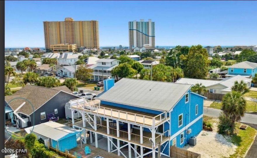 SHORT SALE OPPORTUNITY— Prime Panama City Beach Location! Unlock the potential of this spacious, multi-level beach home zoned for short-term rentals. The ground level offers a private-entry studio apartment with full kitchen and bath, perfect for guests or rental income.
The main residence comfortably sleeps 10 and features two primary suites with ensuite baths, framing a bright, open-concept living area and kitchen with quartz countertops and a large island/breakfast bar. The top floor adds two bunkrooms and an additional full bath, ideal for kids or overflow guests. Wide wraparound balconies on both main levels overlook Treasure Island Marina and Captain Anderson's, plus a sun deck where you can watch the fishing fleet return at day's end. A unique opportunity for a primary residence, vacation retreat, or income-producing investment on the beach. THIS IS A SHORT SALE. ALL OFFERS ARE SUBJECT TO THIRD-PARTY APPROVAL.