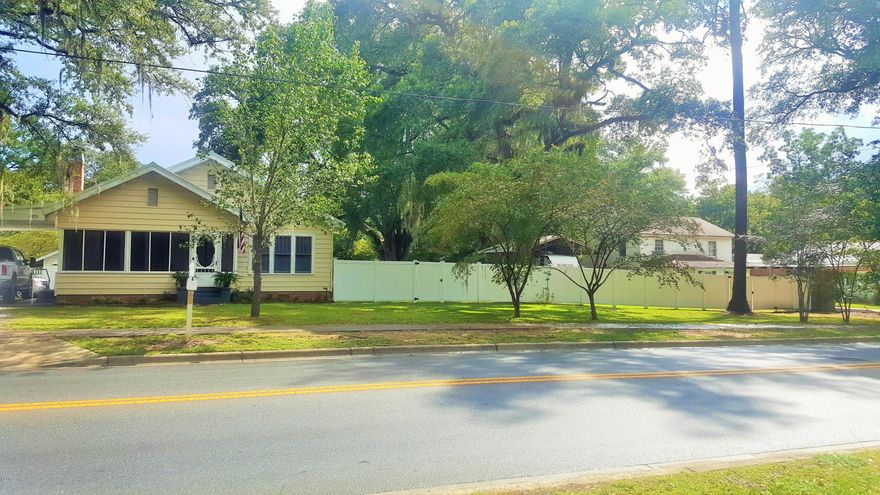 Stunning 3/2 home located on three city lots in the heart of Marianna. You can either sit on your screened in porch and watch the world go by or relax on your back deck and enjoy the privacy. Home has 2,542 sq ft under roof and has had many upgrades over the past few years.  Upgrades are as follows:  50 Metal roof in 2016, AC in 2015, electric 2010, wired for Cat 5, PVC privacy fence 2015, one of the bathrooms was totally renovated to include new sub-flooring, attic is blown in insulation that is 12'' deep. All bedrooms have walk-in closets and the pantry is HUGE. There is a 24 x 24 pole barn that comes with a 30 amp RV plug and 110 wiring.  Detached room is currently being used for a craft room.  Make your appointment today to view this beautiful home.