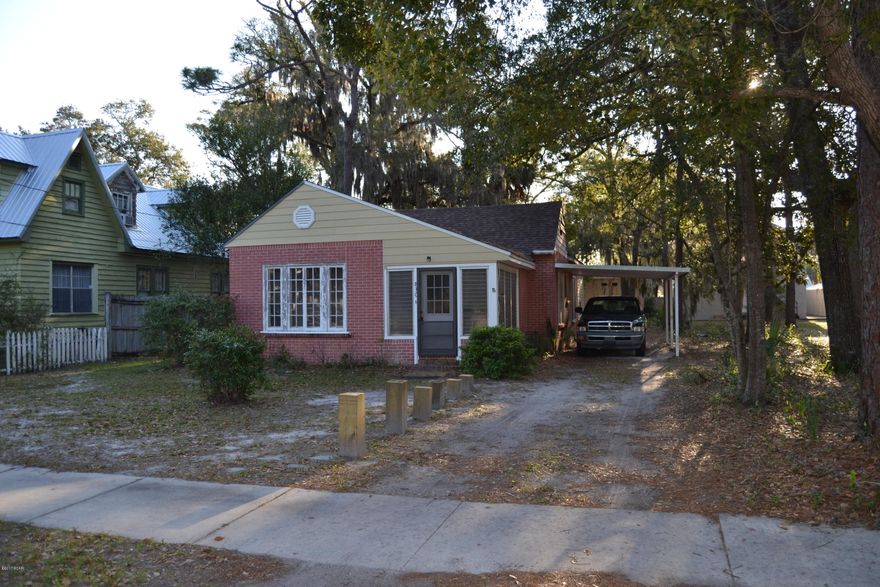 Downtown charm or commercial office you can take your pick. The hard work has been finished as a new roof was engineered to improve the home and includes 30 yr architectural shingles, 30# felt, 100 mph roof straps, hurricane clips and extra insulation throughout. The home is a 2 bedroom, 2 bath home but the bonus room could be a 3rd bedroom. There is a large dining room and living room (being remodeled) There is also a small mudroom at the entrance. The lot is large and beautiful with mature oak trees and an alleyway in the back for dual access. Repairs needed to living room and mudroom are: ceiling installed, new flooring and new windows.



Flooring has been purchased and is included in the sale. The sunroom/mudroom needs drywall put up and the ceiling and flooring installed. All of the ndows are original and there is peeling paint on the exterior window frames. There is no knowledge of lead paint, but it should be tested to be sure. Seller's started renovations and are now unable to finish. Great location that is zoned for mixed use. Seller's are motivated. Come make an offer today!