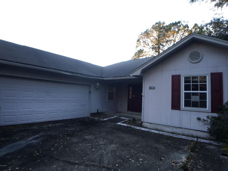 Nice Lynn Haven home on a beautiful street. This spacious home sits on a huge lot with lots of trees. The large living room has a wood burning fireplace, vaulted ceiling, and bay window. The huge eat in kitchen has plenty of cabinets and counter space and a bay window in the dining area. Off the kitchen is a bonus room that can be used as a formal dining room, office or playroom. An oversized laundry room with a deep tub sink is between the garage and kitchen. The master bedroom has yet another bay window, the master bath a soaking tub along with a shower. Step outside to the large screened porch and out to the fenced back yard. There is a separate building that has electricity that could be used for a workshop, game room or converted to a guest suite! Come see this great family home!