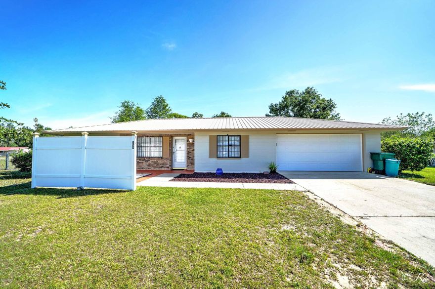 Affordable living on an extra large lot! This 3/2 includes the adjoining large corner lot making it over half an acre. Newer metal roof. The layout features a galley kitchen leading to the 2 car garage. The Master bath is handicapped accessible. Keep the lot for yourself or sell it later. Sunny Hills is home to many swimming and fishing lakes as well as a public 18 hole golf course.