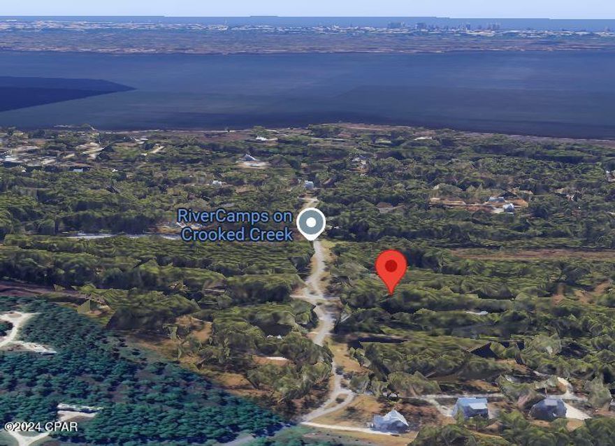 Large, 1.4 acre Lot located on a paved road, near the boat ramp in the gated, waterfront community of RiverCamps in Panama City Beach. Work with a builder of your choice and design your dream home. The community boat ramp gives direct access to the 18000 acre West Bay and IntraCoastal Waterway. The Gulf of Mexico and Shell Island is a 30 minute boat ride away. RiverCamps is a gated 1500 acre nature preserve with less than 450 homesites on 500 acres scattered among an additional 1000 acres of conservation. This golf cart friendly community has over 7 miles of trails meandering through the pines and along the waterways full of wildlife and natural splendor. In addition to the community boat ramp owners enjoy dry-boat storage, day-use boat slips and unlimited use of kayaks and canoes. The rebuilt waterfront community pool is expected to be completed by spring of 2025. Truly an exceptional neighborhood that gets you away from the crowds and traffic yet is only 15 minutes from the shopping and restaurants of Pier Park and the famous white sandy beaches. Less than 10 minutes away is the NW Florida Beaches International Airport and the newly opened hospital.