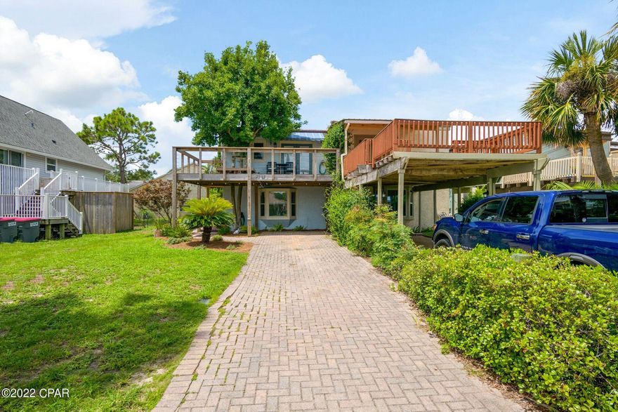 CURRENTLY UNDER CONTRACT, SELLER ACCEPTING BACKUP OFFERS Great location nestled up close to South lagoon and only a few short blocks to the worlds most beautiful beaches! Completely gutted to bare studs in 2008, this beautifully updated townhome has been completely rewired, all new AC ductwork and 3 ton Lenox, spray foam insulation in roof and all walls, all new windows and doors with hurricane panels, beautiful custom cabinets and an outside hot shower to rinse off after you get home from the beach! This home also boasts a new tankless Rinnai instant on hot water heater and irrigation system in the front yard. Reroofed with Sarnafil, the exterior was repainted in 2020 and the upper front and lower back decks were re-stained with deck correct in 2021. Appraisal, wind mitigation and are on file and available.