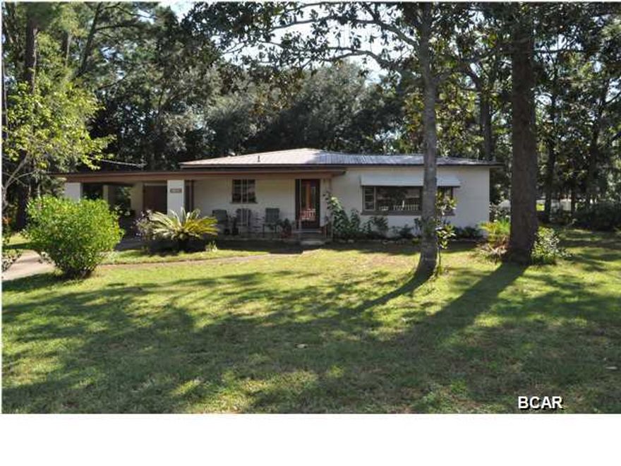 Lynn Haven home that's perfect for your growing family! Located on a corner, this home sits on two lots and along with the 3BR/1.5BA home, there is a workshop in the backyard. Inside the home is a traditional floor plan with a large living area and an eat-in kitchen. There is a bonus room off one of the bedrooms with a separate entrance perfect as an extra bedroom or a home office. The AC was replaced 1 year ago and the metal roof is only 10 years old so your big ticket items are taken care of! Along with the attached carport, there are two driveways behind the home that you access from 10th St. This block home is centrally located and walking distance to Sheffield Park, Lynn Haven City Hall, shopping and several restaurants. All info is approx. and must be verified by Buyers if importa