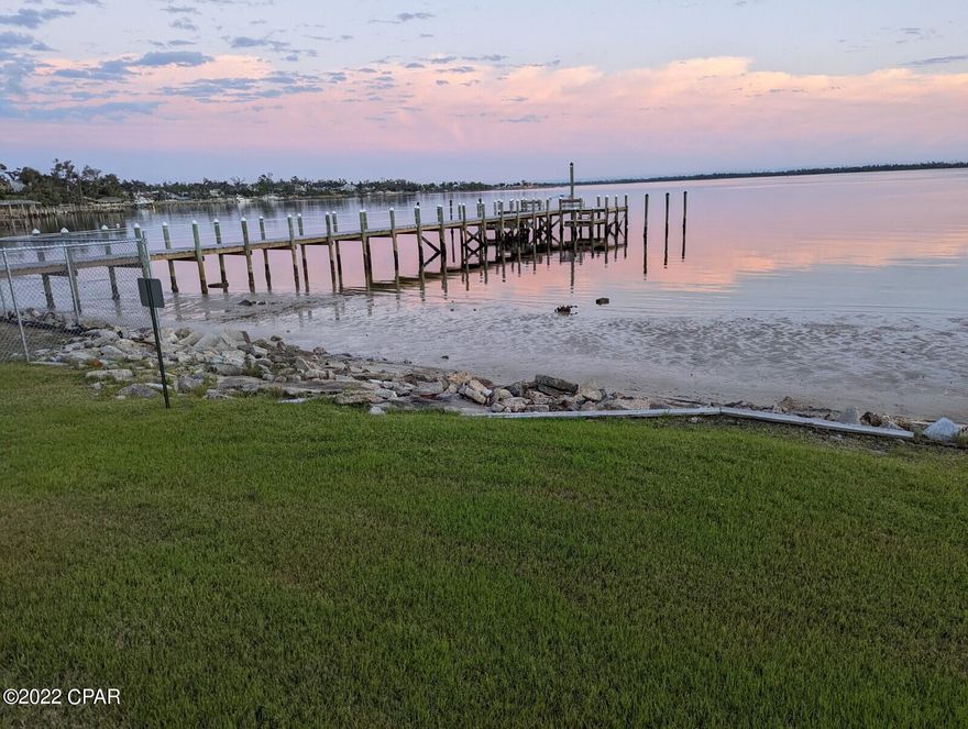 CURRENTLY UNDER CONTRACT, SELLER ACCEPTING BACKUPS, :  Bay front , located on St. Andrews Bay with beautiful bay views.  Large , separated 2br/2bth with open ''renovated'' kitchen /dining/living area.  The cathedral ceilings give the Living-Dining area an expansive, comfortable feel next to the wood burning fireplace. The bathrooms have also been fully renovated. Flooring is newly installed LVP.  2 covered parking spaces. Easy walk to historic Downtown Panama City as well the Cove Shopping Center.  Community Pier allows for recreational boating and fishing.  Large Community Clubhouse next to an expansive community pool area.  Priced to sell As Is.  Please call Agent first to ensure a private showing.  Easy show, on LBX.