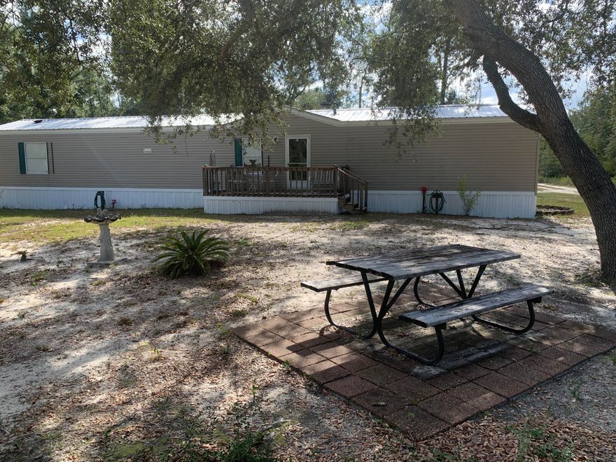 This single wide sits on over half an acre, this home offers 3 bedrooms and 2 bathrooms with a split floor plan. Master bath has a garden tub and separate shower. Spacious laundry room has been added onto home. Has a wood burning fire place and new roof installed in 2020. There are 2 sheds on the property, one is insulated with a window AC unit. There is also a game cleaning station. Lots of privacy, this property it feels remote but it is just a block off US-231. All measurements are approximate; buyer should verify if important.