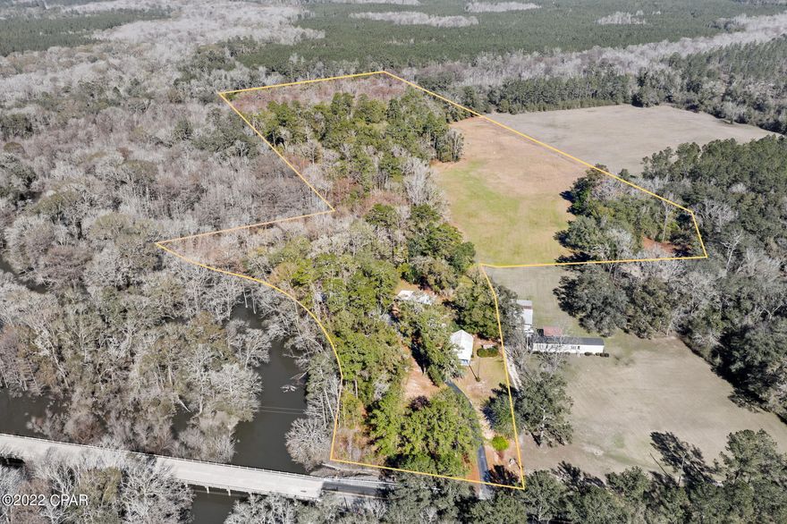 What a Rare Find!!! One of the highest bluffs with over 550ft. of frontage on Wrights Creek.. Approximately 32 acres MOL with 2 homes and out buildings. Some of the property is cleared. Main home is 3 bedroom 2 bath home and second home 3 bedroom and 1 bath.  Bring your horses!  This property has plenty of room for livestock and any outdoor activities.  ALL on a paved road!  This unique find is must see!