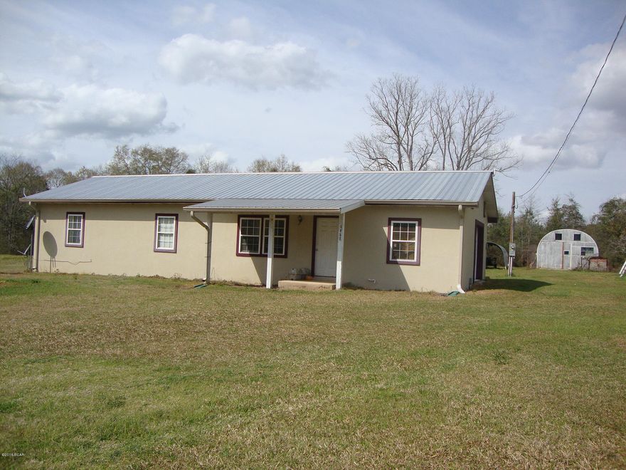 3 Bedroom 2 Bath Concrete Block Home on 1 Acre. Open Concept for Living Room/Dining Room and Kitchen.  Large laundry room. Metal Roof. All appliances stay. Air conditioning system only 4 years old and has metal industrial grade duct system. 2 Car Detached Carport and Storage Building. All steel 36X20 Quonset Hut(building used in military)fully wired and has 9X9 door. Shelving and workbenches stay.  Locate on paved 2 lane highway short distance to town.