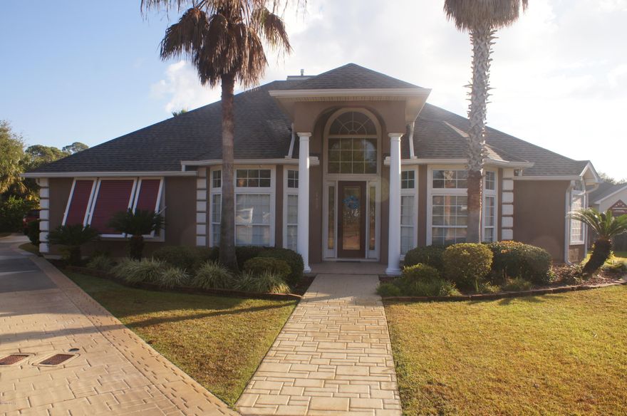 This 4 bedroom 3 bath home is beautiful. It has new porcelain wood tile floors throughout and the master bathroom has just been renovated it is a must see. The kitchen has stainless steel appliances and a double oven. The countertops are corian and it has a kitchen island.  The new lifetime roof was installed in 3/2017 the  a/c & heating system 2/28/2017. New hot water heater 9/2017. It has a large covered porch and open patio by the in ground salt water gunite pool. The driveway is the largest in the neighborhood and the garage is located in the back of house.  Located above the garage is a storage area with pull down ladder.  The house has a surround sound speaker system.  Lots of crown molding and custom trim work. This home design is unique with so many features.  A security system that you can have monitored and outside security cameras that you can monitor from your TV in real time are  motion activates it and it records so it can be reviewed later.  Special lighting inside and out.    The community has a community pool,  hot tub, exercise room and clubhouse.  It also, has two long docks which allows you to fish from the dock  or drop off or pick up someone from the dock in your boat.  The owners are licensed realtors. Please have home measured if important to you.