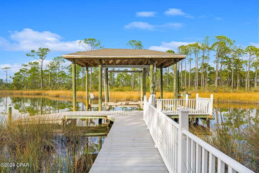 Waterfront Paradise on Goose Bayou
Welcome to 2100 Coral Dr, a stunning 3-bedroom, 2-bathroom home nestled on the serene shores of
Goose Bayou in Lynn Haven, Florida.  Check out the new photos and video! This idyllic waterfront property offers breathtaking views and
unparalleled access to North Bay, making it a true haven for nature lovers and water enthusiasts alike.
Key Features:
Spacious Living: With 2,652 sq ft of living space, this home boasts a bright and airy open floor plan,
perfect for both relaxation and entertaining. The living room features cathedral ceilings and an
electric fireplace, creating a cozy ambiance.
Modern Updates: Enjoy peace of mind with recent updates including a new HVAC system (2023),
windows (2017), and roof (2018). The kitchen is equipped with ENERGY STAR qualified appliances,
a kitchen island, and ample storage.
Outdoor Oasis: The beautifully landscaped backyard is ideal for garden parties and family
gatherings. It features a screened gazebo, perfect for dining al fresco, and a dock with a boat
house/lift for easy access to the bayou. There's also a large RV/boat port to store all your toys.
Wildlife Haven: Experience the beauty of nature right from your backyard. The bayou is home to a
variety of birds of prey and waterfowl, providing a picturesque and tranquil setting.
Prime Location: Situated on a 0.27-acre lot, this property offers privacy and seclusion while still
being conveniently located near local amenities and top-rated schools.
Don't miss this incredible opportunity to own a piece of waterfront paradise. Schedule your private tour
today and make 2100 Coral Dr your new home!