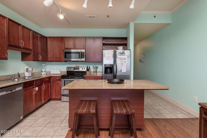 Welcome to Laketown Wharf - where location, lifestyle, and investment potential come together beautifully.  This spacious 2BR, 2BA condo with a bunk room offers approximately 1,262 sqft of comfortable coastal living. Thoughtfully designed for both personal enjoyment and rental income, the unit features a stacked washer and dryer and a flexible layout that easily accommodates guests. Step out onto your private balcony and take in the direct waterfront views of the lake, creating a peaceful backdrop for your morning coffee or evening unwind. Perfectly positioned directly across the street from the Gulf, this condo includes dedicated deeded beach access with a private gate and boardwalk through Pineapple Willy's, making beach days effortless. You're also within walking distance to some of Panama City Beach's most popular attractions, including dining, shopping, and entertainment. Whether you're looking for a vacation getaway, income-producing property, or both, this condo offers a true one-stop destination in the heart of Panama City Beach.