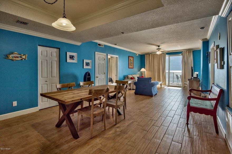 Mere steps from your door, this condo comes with enchanting views over an inviting community pool and spacious balcony perfect for entertaining or catching a one-of-a-kind emerald coast sunset. Warm, beige cupboards, a cozy kitchen and comfy bar stools set the stage for fixing meals and spending time with family and friends.  The new “wood look” tile floors give this property all the warmth of hardwood flooring with the convenience of tile flooring at the beach.  Extending from the kitchen through the dining area and living room, you will find your eyes immediately drawn to endless sliding glass doors where gulf breezes and beach scenes are ever present. The snow-white sand and emerald green waters that draw people to the Panama City Beach region year-round make this property favorable for vacation rental as well.  

Decorated in a variety of blues with charming beach accents, this property offers a neat residence, fun vacation home and investment opportunity all wrapped into one special place. The bedrooms are comfortably furnished and each bathroom features light earth tones, neutral colors and splashes of blues to remind you of the sea, sky and serenity you will find here.  Master bedroom sliding doors offer yet another beachfront vista and fresh air patio.  Covered parking, free WiFi and 5 flat screen TVs add to the appeal, along with a community spa and sauna for pampering yourself. This perfect beachfront condo is ready and waiting for you. Come and see for yourself!