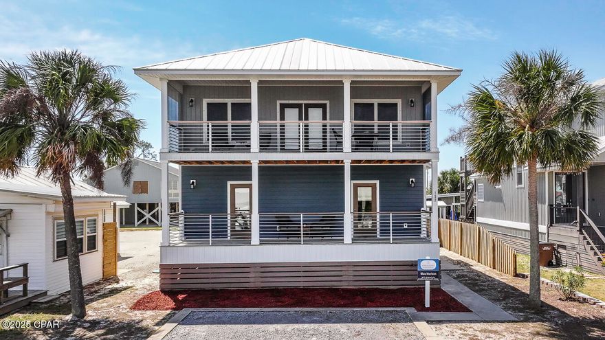 COASTAL GULF VIEW ESCAPE in St. Joe Beach! This gorgeous 4-br/3 1/2-ba home is the perfect rental investment or private retreat, offering the ideal blend of modern comfort & laid-back beachside living. From the moment you arrive, you're greeted by  two inviting front balconies, one which is screened-in, that capture scenic views of the sparkling Gulf waters—perfect for morning coffee or sunset cocktails.  Welcome to an open-concept living area featuring seamless flooring & custom trey ceiling creating a warm, inviting space for entertaining or relaxing after a day at the beach. The heart of the home is a sleek, modern kitchen outfitted with stainless steel appliances, granite countertops & tailored lighting that highlights every stylish detail. Whether you're cooking up a seafood feast or serving snacks at the breakfast bar. a 1/2 bath is located on the living floor for convenience. Each of the spacious bedrooms offers ample natural light & coastal charm, along with three well appointed bathrooms with contemporary finishes. Step outside to your private oasis- a fully fenced backyard and amazing one of a kind oak tree,  a refreshing private pool & plenty of room to lounge or play. Rinse off the salt & sand in the convenient outdoor shower or store your beach gear in the outdoor shed. There's even dedicated boat parking in the large driveway, making it easy to enjoy a day on the water. Just steps from the pet-friendly beach, this home is nestled in a peaceful neighborhood where coastal breezes & sunshine are part of everyday life. Whether you're looking for a high-performing vacation rental or your own slice of paradise, this home delivers beach living at its best—where every detail is designed for comfort, style, and unforgettable memories.  Easy golf cart access from Windmark Beach to Mexico Beach. Nearby Port St Joe offers unique boutique shops & local restaurants serving up the freshest local seafood. Lets ''LIVE THE BEACH LIFE''!