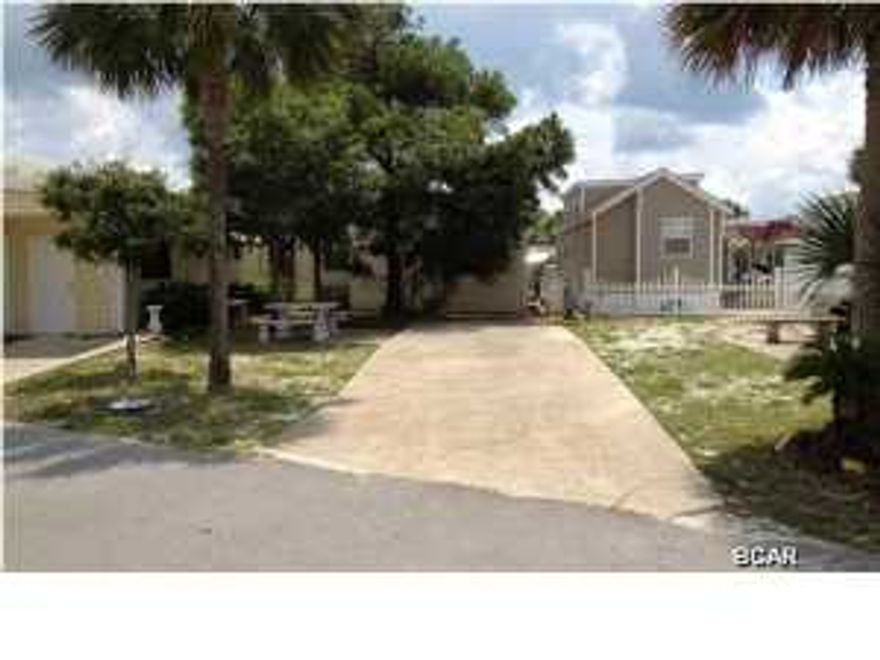 Terrific home site for your RV or to build your own beach house - located in Venture Out, just off Thomas Drive and adjacent to St. Andrew State Park. Currently, the site is set up for an RV - with concrete pad and hookups for electric, water and sewer. The resort features many amenities: gate community with security, all day, every day; private access to the gulf beaches, with pool and clubhouse; a second pool, heated for the winter months, is located along bay, together with a pavillion; a community boat launch, dock for fishing, and convenient slips; two courts await the tennis enthusiast; shuffleboard, basketball court and 9 hole putt-putt golf course provide leisurely fun; picnic areas to feed the family and playground to entertain the kids; attractive landscaping keeps the