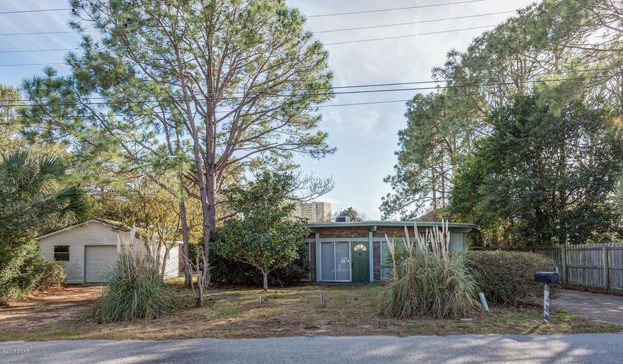 Unique round brick and cedar home in popular Open Sands walking distance to the World’s Most Beautiful Beaches. This round home includes 3 bedrooms, 2 baths, eat in kitchen, dining/living room, and glassed in sunroom. Every room has sliding glass door access to the outside. The home is situated on a 100x100 lot and includes a detached 1 car garage.  All sizes and measurements are approximate-buyer to verify if important.