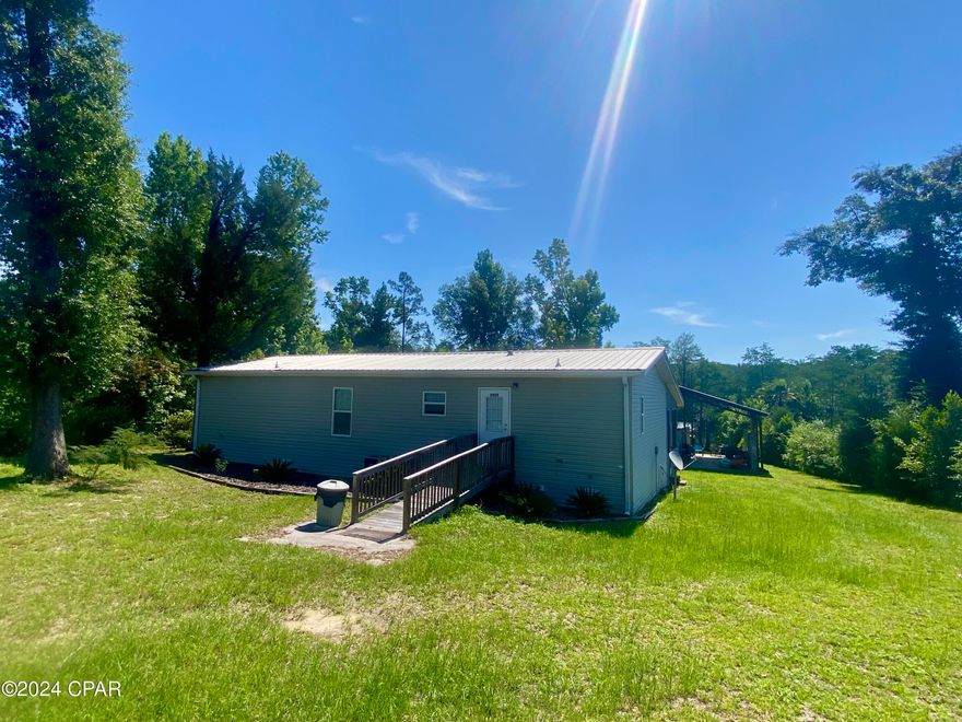 WATERFRONT on Cypress Creek!!  Come enjoy peaceful living in this 3 bedroom, 2 bath mobile home.  The spacious open floor plan offers a view of the water from most rooms.  The screened porch across the back of the home is the perfect place for family gatherings, entertaining and relaxing in the great outdoors.  Enjoy watching nature, fishing & boating from your own private dock that has a built in bench and a stainless steel fish cleaning sink with water and electricity.  Plus a floating boat house that rises/lowers with the water level.  Other outdoor features include a fenced yard, a 36x32 pole barn, a 48x32 pole barn, a 28x11 storage building and 2 RV hook ups!  This place is a FISHERMAN'S PARADISE!!  Whether you want to fish the river or the lake, you're just a minutes boat ride from the Chipola River and Dead Lakes - a 6,700 acre lake that has an excellent reputation for it's bream, shellcracker & bass fishing.  If you love salt water fishing too, this location is perfect!   Located just 35 miles from Port St Joe and the Gulf of Mexico where you can enjoy saltwater excursions and delicious seafood!  Don't miss this opportunity to own your dream waterfront property!
