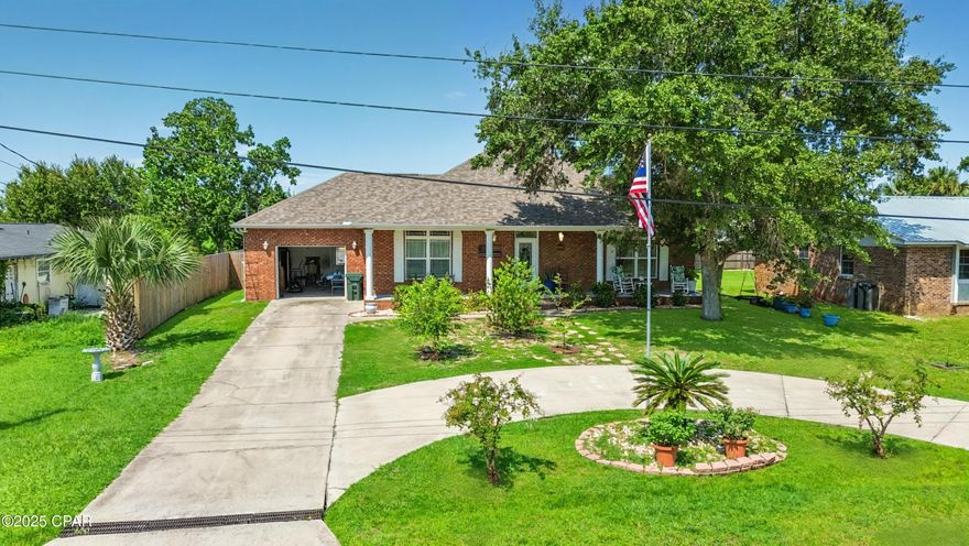 'CURRENTLY UNDER CONTRACT, SELLER WILL CONSIDER BACKUP OFFERS'  Power bill is only the $29 connection fee most months! Solar panels will be paid off at closing and have 20 years left of warranty. Vacant lot behind the house can be purchased to make it a half acre with duel street access. Welcome to 112 Kentucky Avenue, a beautifully updated 3-bedroom, 2-bath brick home in the heart of Lynn Haven. Perfectly situated on a quiet dead-end street just steps from the Bay, this property offers daily water views and quick access to boat ramps, parks, and everything the community has to offer. Inside, you'll find a bright, open floor plan featuring a spacious living room with a gas fireplace, recessed lighting, and built-in ceiling speakers. The kitchen boasts a large island with breakfast bar seating, modern backsplash, pantry, and updated black stainless appliances. The split-bedroom layout ensures privacy, with a generous primary suite complete with backyard access, walk-in closet, and ensuite bath featuring a jetted tub, tiled shower, and granite vanity. Recent upgrades provide peace of mind, including a brand-new roof (2024), new water heater (2023), oversized tile flooring, and energy-efficient solar panels. Enjoy your own retreat with a saltwater pool (just a few years old), large covered patios, outdoor shower, and a fully fenced quarter-acre lot with plenty of room for parking. With its unbeatable location, energy savings, and modern updates, this home combines comfort, efficiency, and coastal living at its best.