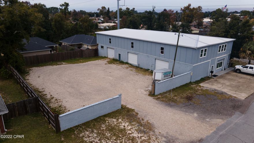Centrally located Climate Controlled 12ft ceiling Warehouse with A/C Office Space + two 2-Bedroom Apartments. Sits on a .39 acre corner lot and located just off Michigan Ave. Easily accessible from both Hwy 98 and 23rd St. Additional parking space in-front of the office will fit plenty of vehicles. Very well constructed of cement blocks and concrete commercial building also featuring a New Motorized sliding gate and new roll-up bay doors. Plenty of possible uses with secure spacious yard accessible by electric gate, like warehouse, defense contractors, suppliers, distribution, R&D, trades contractors, road work contractors etc. There are two 2-bedroom 1-bath apartments on the 2nd floor, with full kitchen with all appliances, living room, laundry room equipped with washer & dryer.