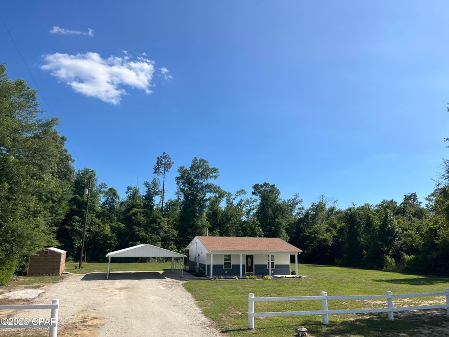 Talk about move in ready!!! Like new home on close to an acre of land (0.93 per survey). Home is situated on a paved highway in rural Grand Ridge, but still just minutes to the new K8 school future location. Convenient access to I10, also within an hr to Dothan AL. and Tallahassee FL.  This property boast covered parking(24'x25'), an outbuilding for storage(10'x16'), a screened and covered back porch(32' total) for grilling, drinking coffee, or just bird watching. The affordable utility bills also make this place desirable. Call for your showing today! All Measurements are approximate please verify if important.