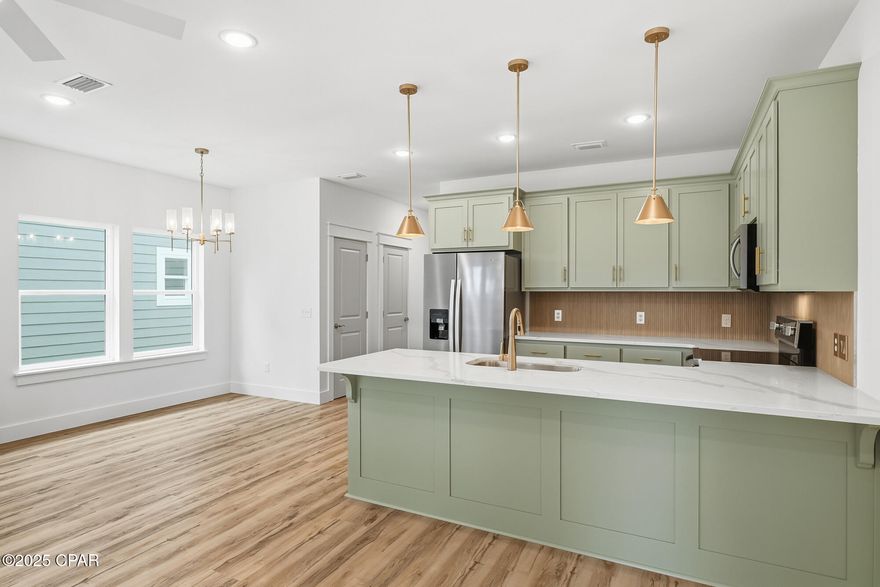 Modern new construction just blocks from downtown Panama City, offering style, comfort, and room to grow. This two-story home features Impact rated exterior doors and windows, cement board siding with board and batten accents, 3 bedrooms, 2.5 baths, 1,582 square feet, and a 1-car garage. All bedrooms are upstairs for privacy and spacious living.

Inside, you'll find beautiful White Oak luxury vinyl plank flooring throughout the main level, paired with real White Oak stair rail accents for a warm, modern touch. The kitchen stands out with quartz countertops, custom cabinets, brushed gold pulls, fixtures, and light pendants, plus stainless steel appliances. Bathrooms feature tile flooring and designer finishes, including a master suite with double vanity, walk-in shower, and tray ceiling.

A versatile mini mudroom sits off the garage next to the half bath, perfect for dropping shoes, keys, or bags after coming in. It also connects to the main hall from the front entry for easy access. Additional features include a pantry and a spacious under-stair storage closet.

Built for comfort, the home includes 2x6 exterior walls, insulation between floors for sound reduction, high ceilings on the main level, and carpet in the upstairs bedrooms. An irrigation system is already in place.

Zoned MU-3, this deep 33' x 150' lot with alley access gives you the option to add an accessory dwelling unit (ADU). Great for rental income, a guest house, or future flexibility. Buyer to verify requirements.

A fresh, thoughtfully designed home close to everything downtown has to offer. Don't miss out!