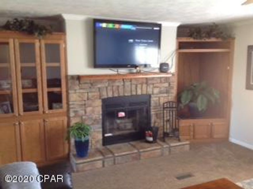 10 Acre Beautiful Homestead, DWMH with all the Extras. Spacious home with huge 16' x 25' cover Deck overlooking open acreage with Pecan & Fruit Trees. One area of the backyard is electrified dog run. The home is in excellent condition very light and open. Wood burning fireplace in the family room, eat in kitchen with large pantry and plenty cabinets. Master bath has double vanity with separate shower and tub. There are 2 out building a 20 x 30 and a 12 x 20, and a two car covered parking area.  The roof is little over a year old. The home offers a warm welcome with its custom front entrance. Plenty of room with a lot of privacy.