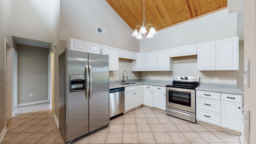 Move in Ready and very spacious 3 Bed 2 Bath Brick Home in Panama City with bonus room! The home features beautiful vaulted ceilings in the living, dining and kitchen areas. There is a bonus room with both interior and exterior entrance that could be used as a man cave, large office or 4th bedroom. The open floor plan is perfect for living and entertaining. Tile throughout the home ensures low maintenance. There is a garage and attached carport. This home is Move In Ready. Copper Wiring, Dimensional shingle roof 2019, fresh paint, and much more! Don't wait, Schedule your tour today! Virtual tour / virtual walk through and video available