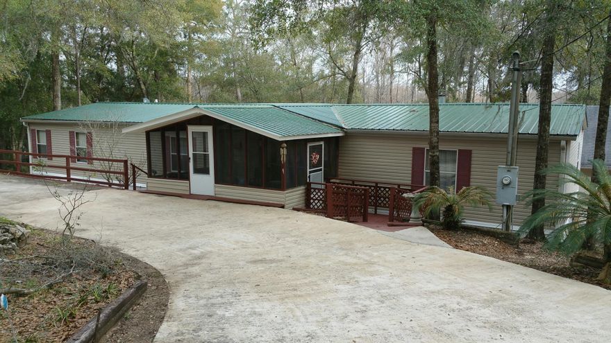 Beautiful HUGE doublewide on Bowen Lake in South Washington County. Looking for a weekend getaway or a really nice place to call home this is it. This home has walk in closest in ALL the bedrooms and in master has one that you could put a bed in. Lots of storage with this very well maintained home.A large laundry room, kitchen with lots of cabinets and a breakfast bar too. Living area open to dinning area and is big enough for any and all of your furniture with a gas fireplace and glass doors going out to the big wooden deck, what a view of the beautiful Lake Bowen. Large storage/man cave on the second floor of the huge workshop and an easy walk to the cook house out by the lake. The back yard has a small chain link fenced area to keep kids or pets away from the lake . The front yard has a circle concrete driveway and a side parking pad .Nice screened front porch and lots of flowering plants.The home has had several updates a new metal roof in 2015 ,a/c in 2014,dishwasher and stove in 2014.You will not be disappointed when you see this lake front home. No cats or dogs inside , just a bird. One of the bedrooms is handicap equipped with an electric rail that runs from one bedroom to the bathroom in the hall. With the right price it can stay or owner will remove it.