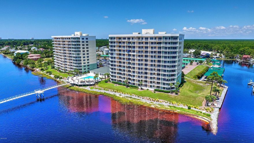 I doubt you can even imagine panoramic views of a marina, the St. Andrews Bay, the Intracoastal Waterway, the Hathaway Bridge, and Mother Nature in all her glory. It's for real! The 10th floor end unit at Hibiscus By the Bay with a wrap-around balcony is the absolute ultimate in condo life! Take in the spectacular view from the far Tower #1 where the boats are outside your windows. Your reasonable association fees include the Master insurance policy for the building and the common areas. They also include basic cable, water, sewer, pest control, and trash disposal. Meet your neighbors because there are no ''short term'' rentals here-- just a great group of people! Boat slips and Garages are often for sale or for rent. The use of the marina, pool, tennis courts, security gate, fitness center, hot tub, walking path, elevators, a 50 yard Fishing Pier and a community room are all a part of the lifestyle you can own!  This address is in the Breakfast Point School District. Life is great! Don't miss out. Keep the furnishings that are there now!