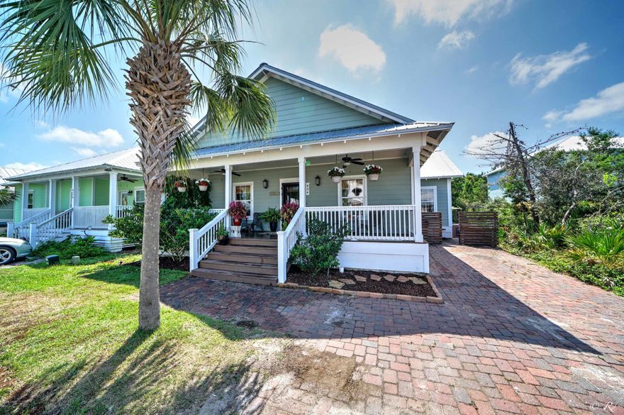 'CURRENTLY UNDER CONTRACT, SELLER ACCEPTING BACKUP OFFERS  Beautiful Beach House about 1/2 mile to the beach. Immaculate condition. Located in Paradise Grove, a gated community  on the west end of PCB. The sought-after neighborhood has a huge community pool with extra parking. This home features too many upgrades to count. There are matching granite counter tops in the kitchen and bathrooms. The custom kitchen island, high end crown moldings and Bamboo Floors are a must see.   CUSTOM OUTDOOR KITCHEN with built in grill, refrigerator, Kegorator, custom heated fireplace, mounted flatscreen TV.. There is also a built in storage unit connected to the home. There is even a heated outdoor shower! A living room outdoors perfect for relaxing and entertaining. Washer and Dryer do not convey