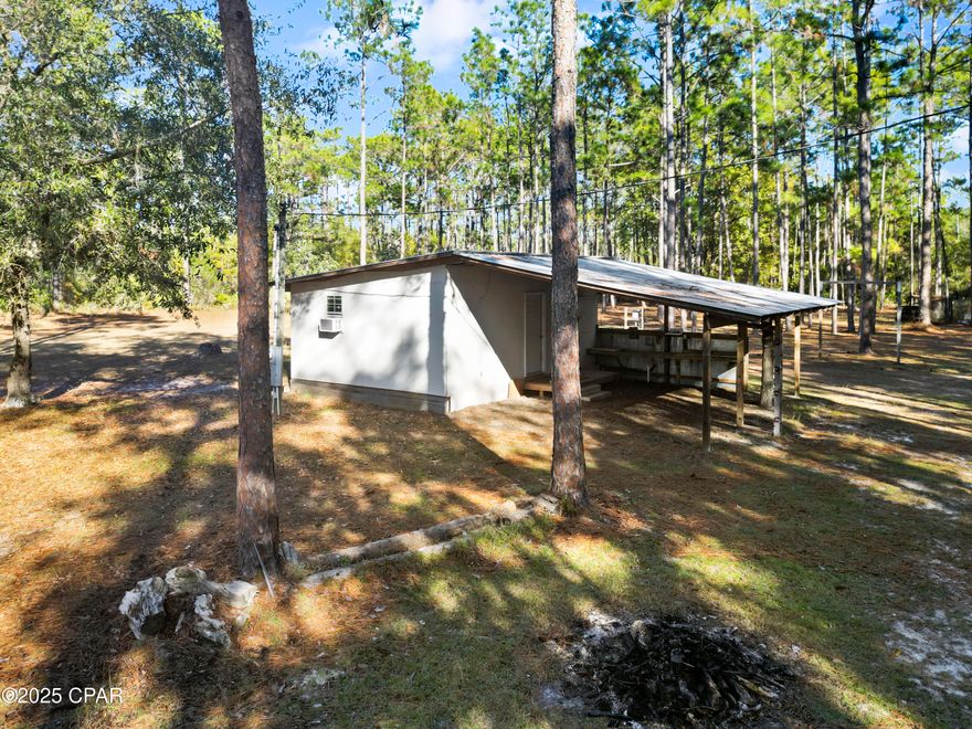 Welcome to 13563 SW Forest Road 141 in Bristol, Florida, an outdoor retreat set on 3 acres within the Apalachicola National Forest. This one-bedroom, one-bath hunting camp offers a comfortable and practical setup for enjoying time outdoors year-round.

Inside, the camp provides a simple living area designed for easy weekends and extended stays. A covered lean-to off the camp house creates a great space for gathering, relaxing, or preparing for the day's activities. The property has power in place, making it well suited for longer visits and added convenience.

Outside features include dog pens, a septic system, and four existing RV hookups, with the ability to add a fifth. The open acreage allows room to spread out, host guests, or enjoy the quiet surroundings.

Located within the Apalachicola National Forest, Florida's largest national forest spanning approximately 630,000 acres, this area is known for its extensive trail systems, diverse wildlife habitat, and public lands used for hunting, hiking, horseback riding, and other outdoor recreation, subject to applicable regulations.

Whether you're seeking a hunting camp, a weekend escape, or a basecamp for outdoor adventures, this property offers flexibility, space, and a strong connection to nature.

Schedule your showing today and see how this property can support your outdoor lifestyle.