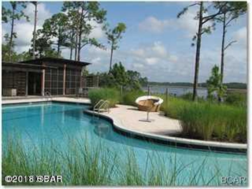 SELLER WILL CONSIDER OWNER FINANCING---BOAT FRIENDLY PARADISE IN A GATED COMMUNITY. Get the best of all worlds--a  quiet lake front community with all the bells & whistles that the luxury resorts offer- all just minutes to the beach. A gated community offering amenities including a community pool, conference center with kitchen, fitness center, meeting area, pool, spa, boat docks, activities center with canoes, kayaks, & bicycles.. No time limits build out date. A truly amazing opportunity! All measurements are approximate & should be verified if important.