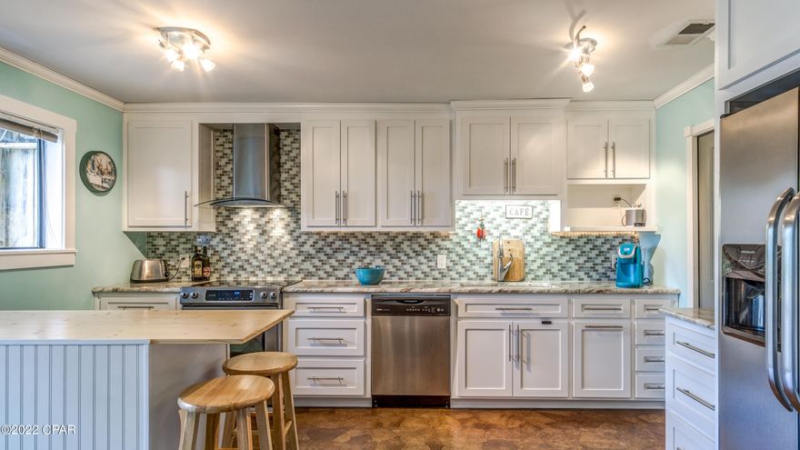 GREAT Short term rental potential ($75k RP)! Close to the beach and with a sneak peak of the lagoon from the upstairs balcony. This 2-bed/2-bath home has been completely renovated, with crown molding in every room. Kitchen is open and full of light with slide glass doors to the backyard deck, custom cabinets, granite countertops, tiled backsplash, large walk-in pantry. There's a full bathroom downstairs and a cozy living room. Upstairs master bedroom has a  accent wood board wall. Master bath has wainscoting and shiplap walls, marble counter and large walk-in shower. Both guest and master closet have double barn doors. Kitchen cabinets, appliances and metal roof in 2015, upstairs deck in 2016. HVAC in 2017. Stackable washer/Dryer and WH in 2019. Currently tenant occupied, lease is $1,260 tenant is vacating on MARCH 1st 2022. Pictures prior to tenant occupancy. Property in Flood Zone AE8, never flooded in the past 10-years, transferable flood insurance is $532/year. All measurements are deemed correct, buyers should verify if they are important.