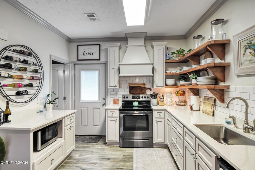 CURRENTLY UNDER CONTRACT, SELLER ACCEPTING BACKUP OFFERS. Walking into the home you'll find the most beautiful renovation, showcasing the gourmet kitchen with attention to detail prevalent throughout this open floor plan.  The sellers didn't skip a beat with finishing touches such as floating shelving in the kitchen, super cute wine bar for entertaining, beautiful coastal looking ceramic wood tile flooring, and ship lap on the living room wall makes this beach home one of a kind in this development and a perfect coastal retreat. Relax with friends and family on the back patio complete with an outdoor shower. Enjoy the ocean views from the second floor primary bedroom balcony. This home boasts the largest side yard and parcel in this unique group of townhomes and would make for an ideal... vacation property.  Just bring your flip flops and sunscreen!  In addition, NO HOA!!  New roof, siding, drywall, insulation, and tankless water heater installed in 2019.