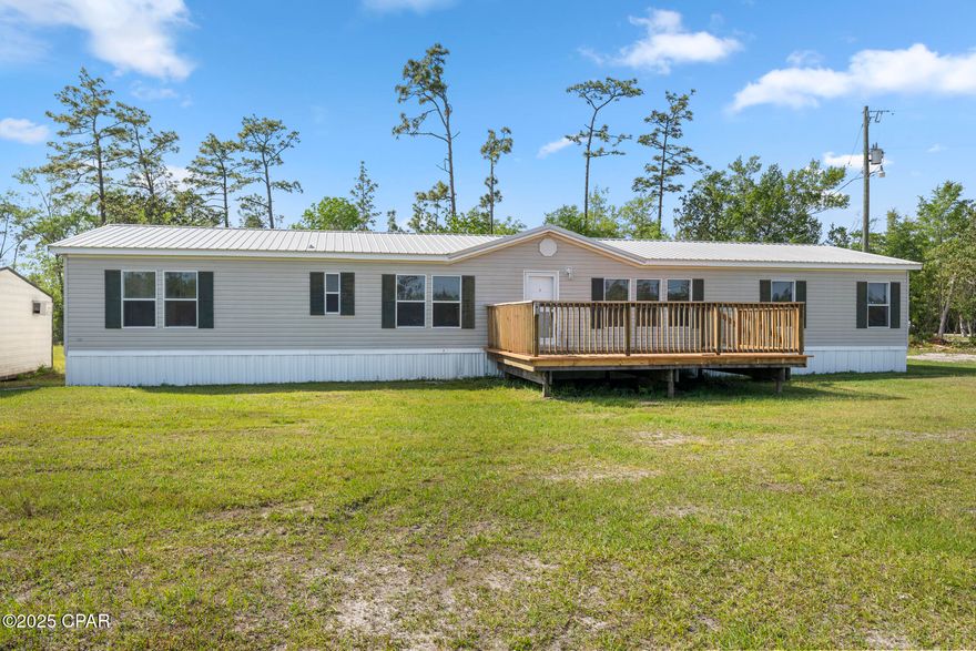 Country living at its best! Move right in to this beautifully updated 4 bedroom 2 bath home on 5 acres! Enjoy an open, airy layout with a spacious living room, separate den, and split floor plan. Brand new water heater and HVAC system for peace of mind. The large kitchen boasts ample cabinet space, a breakfast bar, and plenty of room for family gatherings. Just off the kitchen, the den and living room are flooded with natural light thanks to large windows that frame peaceful views of the surrounding property. The spacious master bedroom offers a private retreat with a generous walk-in closet and an ensuite bathroom. Three additional bedrooms and a second full bathroom provide plenty of space for family, guests, or hobbies.