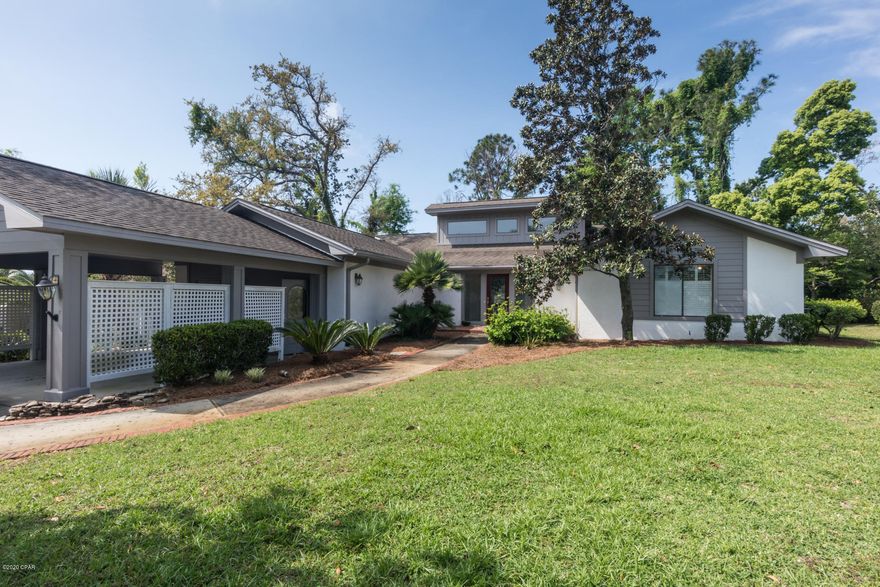 Priced to sell!  This wonderful home in the desirable community of Bay Point has great curb appeal and is ready for you!  Open floor plan with large living, dining room, kitchen, and master that opens to your back patio.  The exterior has inviting spaces with an oversized back deck and large trees for private feel, space for a firepit hang out area, welcoming front walkway, carport that fits 2 cars and can be enclosed to be a garage.  Extra features include a huge laundry room that has been used as a bonus room, office, or craft room and large workroom off of carport for storage and workspace. Bay Point life includes a golf cart lifestyle with marina, golf, tennis,next door Sheraton Resort waterfront restaurants and bars, walking paths, and more! Call today!