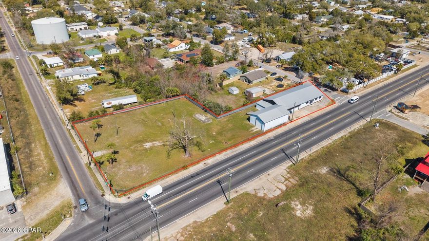388' OF PRIME HWY 98 FRONTAGE • 1.26 ACRE CORNER LOT • FLEXIBLE MIXED-USE ZONING - Position your business on one of Panama City's most visible commercial corridors! Located directly on Business Hwy 98 (E 5th Street) with an AADT of 19,300 vehicles, this 1.26-acre corner property offers an impressive 388' feet of prime highway frontage, providing exceptional visibility, accessibility, and marketing exposure. The fully fenced in property allows two convenient access points for ingress and egress, making the property ideal for customer access, deliveries, and operational logistics. 

Zoned as Neighborhood Downtown (ND), this flexible mixed-use zoning designation allows for a broad range of potential commercial, residential, and mixed-use development opportunities (more information in document section).

The property features roughly 6,200 square feet of total building space, including the main operational building with a reception area, two offices, three bathrooms, and a spacious 52'5'' x 32' open sewing and multi-purpose workspace. The building also includes a 43' x 44' receiving and logistics area, currently unfinished but fully equipped with its own HVAC system and two roll-up doors, offering flexible space for storage, production, or distribution operations. In addition, the property includes a separate 1,500-square-foot heated and cooled welding workshop, also equipped with roll-up doors, providing a functional workspace suitable for fabrication and mechanical uses. *Newer HVACs on site and a 2019 metal roof. 

Located within the Millville Downtown District and just minutes from the revitalized  Downtown Panama City waterfront, the property lies within a Community Redevelopment Agency district (CRA), providing potiental incentives and grant programs  that may support property improvements or redevelopment. 

The established business currently operating on the property, is also available for purchase in conjunction with the property; however, the business valuation is separate from the advertised real estate price. Bob's Top Shop is a well-established custom awning and canvas fabrication business with deep roots in Panama City, known for producing high-quality commercial and residential awnings, marine canvas, and specialty products throughout NW Florida. With decades of brand recognition, repeat clientele, and strong community relationships, this presents a rare opportunity for an owner-operator, contractor, or investor seeking a respected local brand with continued growth potential.  

Whether you're interested in acquiring the property as a ready-to-go operation or exploring the many development possibilities for your own business, this highly visible and strategically positioned site offers endless opportunities. Don't wait, schedule your showing today!

Parcels 22284-000-000 & 22704-000-000 being sold together. Buyer to verify all measurements.