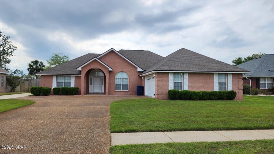 The Woods Subdivision is a highly desirable location in the heart of Panama City. Just two minutes to 23rd Street where you can reach restaurants, shopping, banks, doctors, etc., or Baldwin Road to Hwy 77 or Publix in Sweet Bay. This all-brick home has been very well maintained, and you'll love the newer (2015) full-sized garage out back with power outlets, lighting, work bench, and parking for two vehicles. The large backyard allows for the addition of a swimming pool but also has a covered porch to enjoy your morning coffee. As you walk through the front door, you'll enter the family room with beautiful brick fireplace, custom built-ins, plug-n-play surround sound, and a separate formal dining area. The large kitchen has abundant cabinets for storage, counter height bar for stools, a built-in desk, and a breakfast nook. Behind the kitchen is a generously sized laundry room, with cabinets and large counter, that leads out to the main oversized garage with more cabinets. The master suite is off from the kitchen and has a large sleeping area, a super-sized walk-in closet, and a beautiful bathroom with double vanities including make-up area, large jacuzzi tub, and separate shower. This split design offers two more bedrooms with large closets on the opposite side of the family room as well as a full-sized bathroom. Included in the sale are all kitchen appliances including refrigerator, front-load washer and dryer, 2'' horizontal blinds throughout (2022 & 2024), exterior glass doors (front & inside garage doors), electric fireplace/logs insert (2019), and newer roof with safety features that lower insurance premiums. Separate irrigation meter installed for lower water bills. Zoned HVAC with three thermostat controls for ultimate comfort and UV light for better air quality. Schedule your showing today.