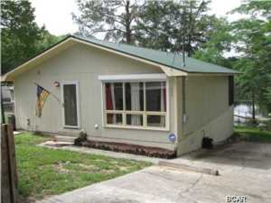 WOW !! A very well constructed and well maintained WATERFRONT HOME on COMPASS LAKE, for an incredibly LOW PRICE ! Seller has been transferred too far away to use, so said ''SELL IT QUICK''. This 2 Bedroom 2 Bath home is on Paved Road with a Dock, Boathouse, and Electric Boat Lift fronting on Jack Pond, which gives direct access to the main portion of Compass Lake. Compass Lake is an approximately 600 acre lake that allows gas motors, and is the Premier Lake in North Florida for Recreational use because of its Clean Clear Freshwater for Swimming, Skiing, Fishing, etc. Conveniently located just 35 minutes North of Panama City and 15 minutes South of Interstate 10. Very Comfortable home with good sized rooms, Fireplace in Family Room, and a Peaceful Relaxing Screened Balcony running all