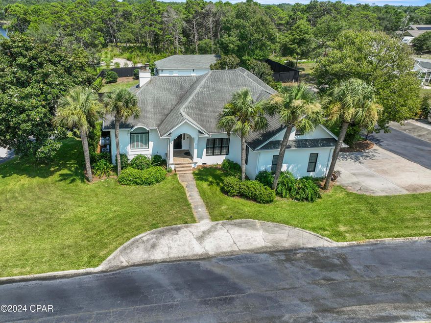 CURRENTLY UNDER CONTRACT, TAKING 
 BACKOFF OFFERS...On the desirable west end of the beach  located on Lake Powell-the largest coastal dune lake in Florida- in the gated community of 9 homes Palmetto Bluff. This custom home sits on over half an acre with an additional detached 4 car garage with bonus room/gym. Enjoy the lakeview from multiple rooms. Unique features throughout- formal living and dining rooms, kitchen/family room, 2 fireplaces, solid oak hardwood floors and trey ceilings. Master bedroom with his and her bathrooms with walk-in closets. Four bedrooms, three and one half baths, attached 2 car garage along with a Kohler generator that will power the whole house. Remodeled kitchen with custom cabinetry, solid marble counter tops, matching backsplashes and waterfall kitchen island, stainless steel appliances and walk in pantry. New bathroom tile, vanity and plumbing fixtures. Large private fenced in drive through yard, must see to appreciate Community dock for enjoying jet skiing, water skiing, kayaking, fishing, paddle boarding, etc. Property has 
5 feet of lakefront with a private gravel path to the lake. Anchor your boat and walk to the beach.... Near 30A, 10 minutes to Rosemary Beach, Pier Park and Frank Brown Park. On Lake Powell and just Blocks to the Gulf of Mexico.... All information believed to be correct but should be verified by the buyer.