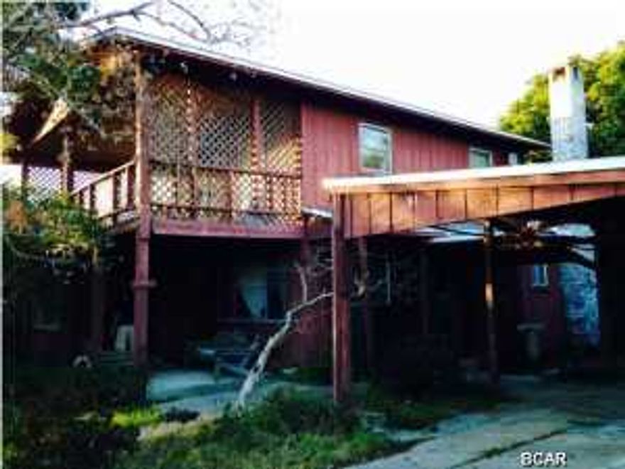 CHARMING AND AFFORDABLE 3BR FLORIDA BEACH COTTAGE on a quiet, corner lot less than 2 blocks from the water!!! This amazing home was handcrafted and is full of special unexpected touches lovingly incorporated throughout the home. It is being sold mostly furnished, comfortably sleeps 8, and is a short walk to the beach, but also has access to Lake Powell on the North side of Back Beach Rd. Per owner, new roof and new well installed last year. Vacant lot next door is included with this purchase so the possibilities are endless. Both properties are in Flood Zone X so NO FLOOD INSURANCE IS REQUIRED!!! CALL YOUR REALTOR TODAY to schedule a private showing of this one-of-a-kind gem! All room sizes are approximate--please verify if important.