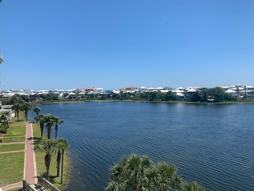 Sit on your covered balcony and enjoy views of the Gulf of Mexico and Lake Carillon.  Dip your toes in the water and purchase this one bedroom condo with beautiful views across Lake Carillon and to the Gulf of Mexico.  This unit is a short stroll to 4 pools, 2 hot tubs, tennis courts, basketball court, playground, and 3,900 linear feet of sugar sand beaches.  This is a great, affordable, entry level unit for rental, second home, or investment property.  Enjoy the privacy of a Gulf Front community only minutes from 30-A to the west and Pier Park to the East. Downtown Carillon Beach has 3 restaurants, a fitness center, yoga studio, and general store for beach stuff, bike rentals, the latest in beach fashions, paddle board rentals and more.