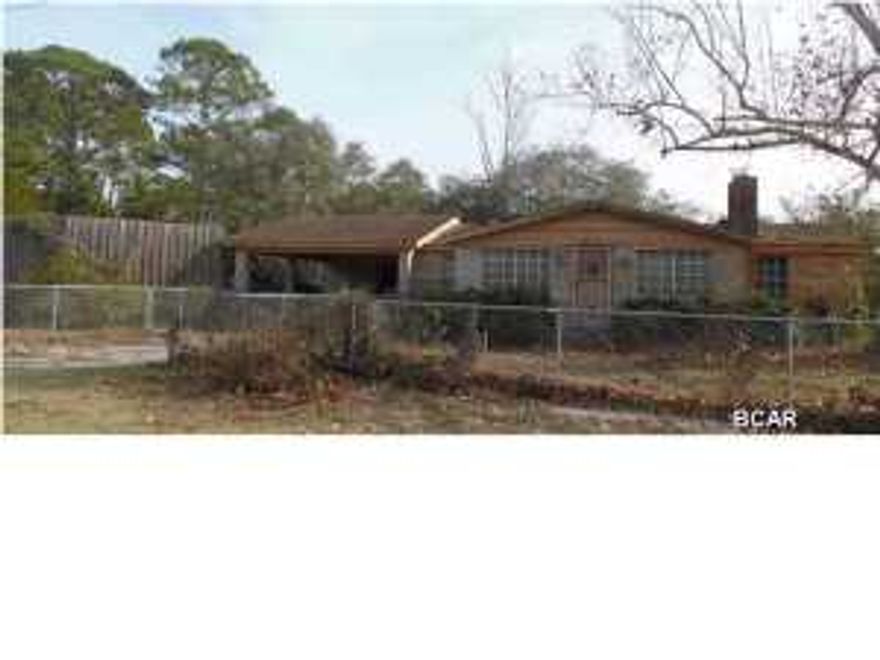 This brick home is 1.5 blocks to the beach, with an inground pool and a like-new, oversized 2 car garage. The half-acre lot is fenced and the Gulf is visible from the front yard.