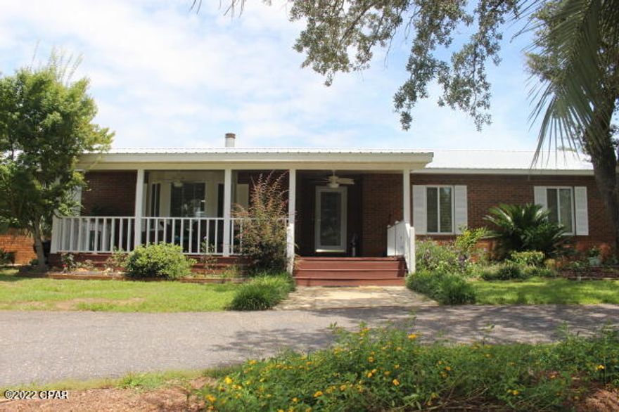 'CURRENTLY UNDER CONTRACT, SELLER WILL CONSIDER BACKUP OFFERS'  Why leave home when you can live off the land here.  Start your own private mini farm.  You can fish & farm on your own space & time.  Plenty of room for your garden  & to plant more fruit trees.  Nice established blueberry patch along with lots of flowering bushes & palm trees. Chain link fenced stock pond & there's a separate swimming hole that's been started at the creek that runs thru this property.  Two fenced pastures for your cows and goats or even horses.  Water lines through out. Property has two wells & two septic tanks along with a couple of out buildings. Read more.. A corner location with two sides on paved roads. The property has been recently surveyed which saves an added expense for the buyer.  The interior is bright & clean with wood laminate flooring thru outThe wood burning fireplace is sure to heat up the house. Work from home there's a space perfect with a view for your private office or use as your separate family room or the kids game room. This space adjoins the large walk in pantry / storage room for your freezer & shelving for can goods and small appliances. The shaded front porch adds more outdoor living space with yet another view of your woods & pond. Worth the drive to come see for yourself if you are not a local yet.  You won't be disappointed. You need this!