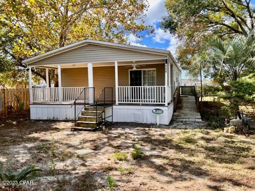 Welcome to your coastal home!   Conveniently located on the coveted West End, you are just moments away from the pristine beaches of Panama City Beach.  This 5-year-old residence is move-in ready, catering to those in search of a primary residence, investment property, or seasonal home. Situated on a large 60 x 120 lot just off Back Beach Road, this energy-efficient 3 bedroom 2 bathroom home offers flexibility to accommodate your Florida lifestyle - you have plenty of room to park an RV or boat at your residence.  The spacious kitchen has like-new appliances, seamlessly connecting to the expansive living area. Dining area offers easy access through sliding glass doors to the large covered front porch to sip your morning coffee and enjoy the cool gulf breeze. Master bedroom features a walk-in closet and ensuite bathroom with double vanities. Hall bath features a bath and shower combo while additional bedrooms have ample closet space. A custom built wood ramp provides easy access to the entry door. You are just a few steps from retail shopping, a bicycle ride to the beach, a 5-minute drive to Pier Park, and just 10 minutes away from 30A and Lake Powell. Don't miss this perfect blend of comfort and opportunity.  Call today.