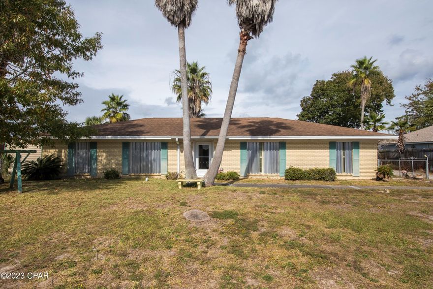 BACK ON THE MARKET - NO FAULT OF SELLER.  Your dream home awaits!  Step into this solid brick home built in 1972, boasting 3 bedrooms, 2 baths, and ample living space with separate dining room, 
living room, and family room. The large screened-in patio adds the perfect touch of relaxation to your everyday life.
   Imagine the possibilities of owning a home with 3 additional outbuildings, a spacious 100 x 100 yard, and an extra-long driveway. The new windows installed in 2013 ensure energy efficiency and a modern touch to the property. Luxurious Vinyl Plank flooring has already been purchased, just waiting for your personal touch. The golf cart community of Open Sands is nestled on the North side of Front Beach Road and this home is just a few short blocks to the Gulf of Mexico and sandy white beach!
   Don't miss out on the opportunity to make this house your own. Create lasting memories and turn it into your dream home today!  Sellers agent to pay $500 toward Old Republic Home Warranty for buyer.  Close to Pier Park, Walmart, Target and restaurants. If measurements are important, please verify.